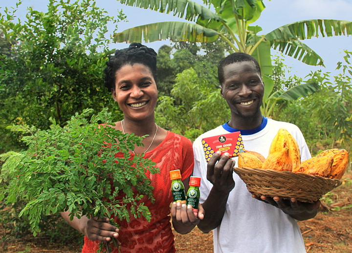 Haitian smallholder farmers holding moringa leaves and cacao pods along with the new products made from each: Kuli Kuli’s Moringa Green Energy shots (left) and Taza Chocolate’s Stone Ground Haiti bar (right). These two items debuted at Whole Foods Market in the U.S. this month, marking an export milestone for Haitian agriculture. Photo: Sebastian Petion.