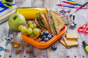 Lunchbox with sandwich, apples, and banana